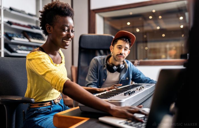 Woman and man creating music in the studio