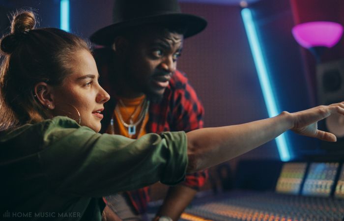 Woman and man in the control room of a music studio