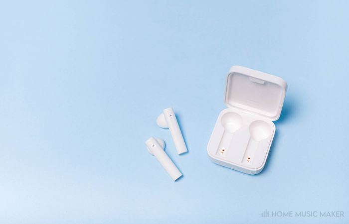 A Photo Of Airpods On A Blue Background