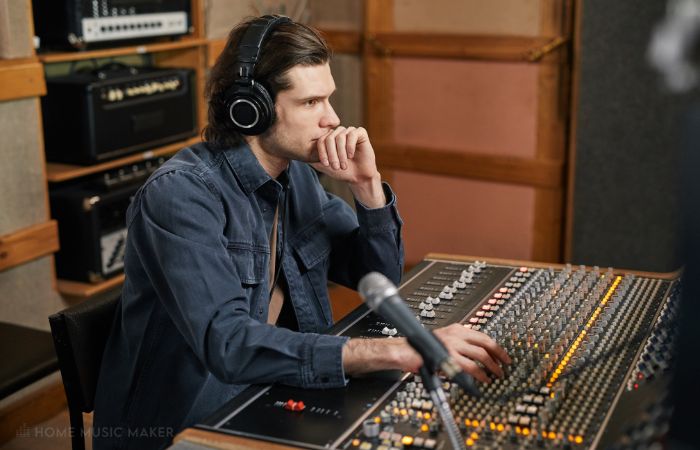 Man Mixing Music Through Studio Headphones